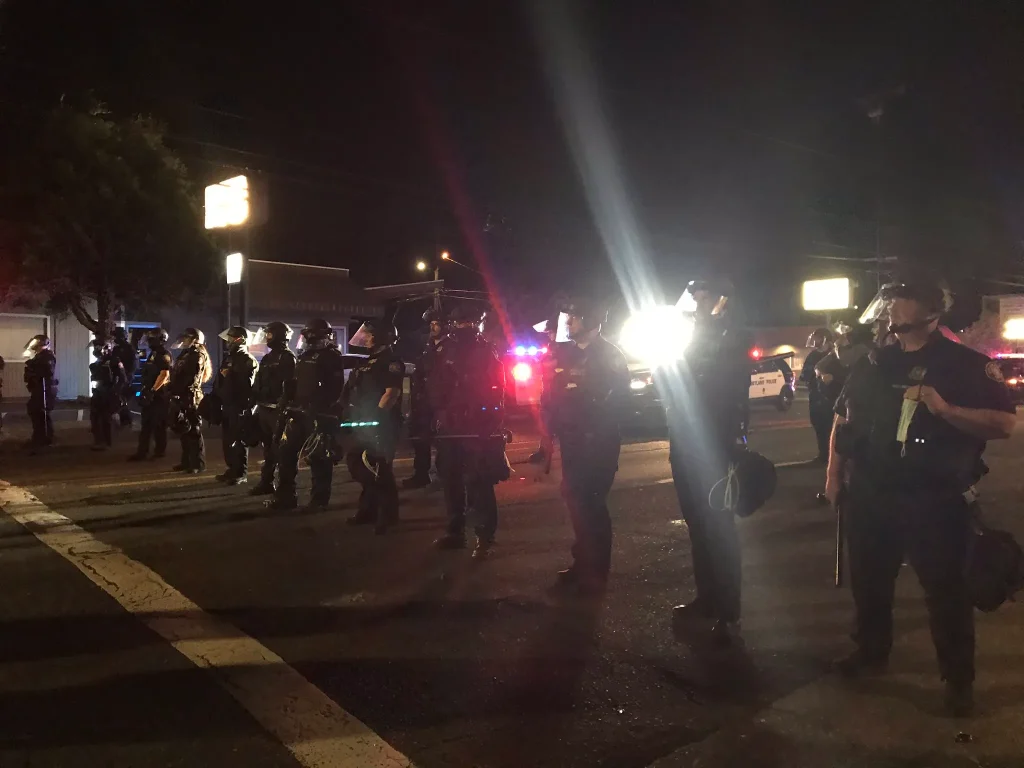 cops in riot gear standing in a line
