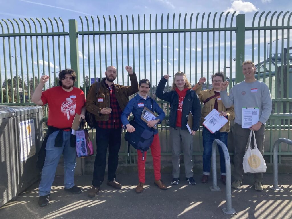 Six members of Portland DSA's Ecosocialist transit survey team at an 82nd Avenue transit stop.