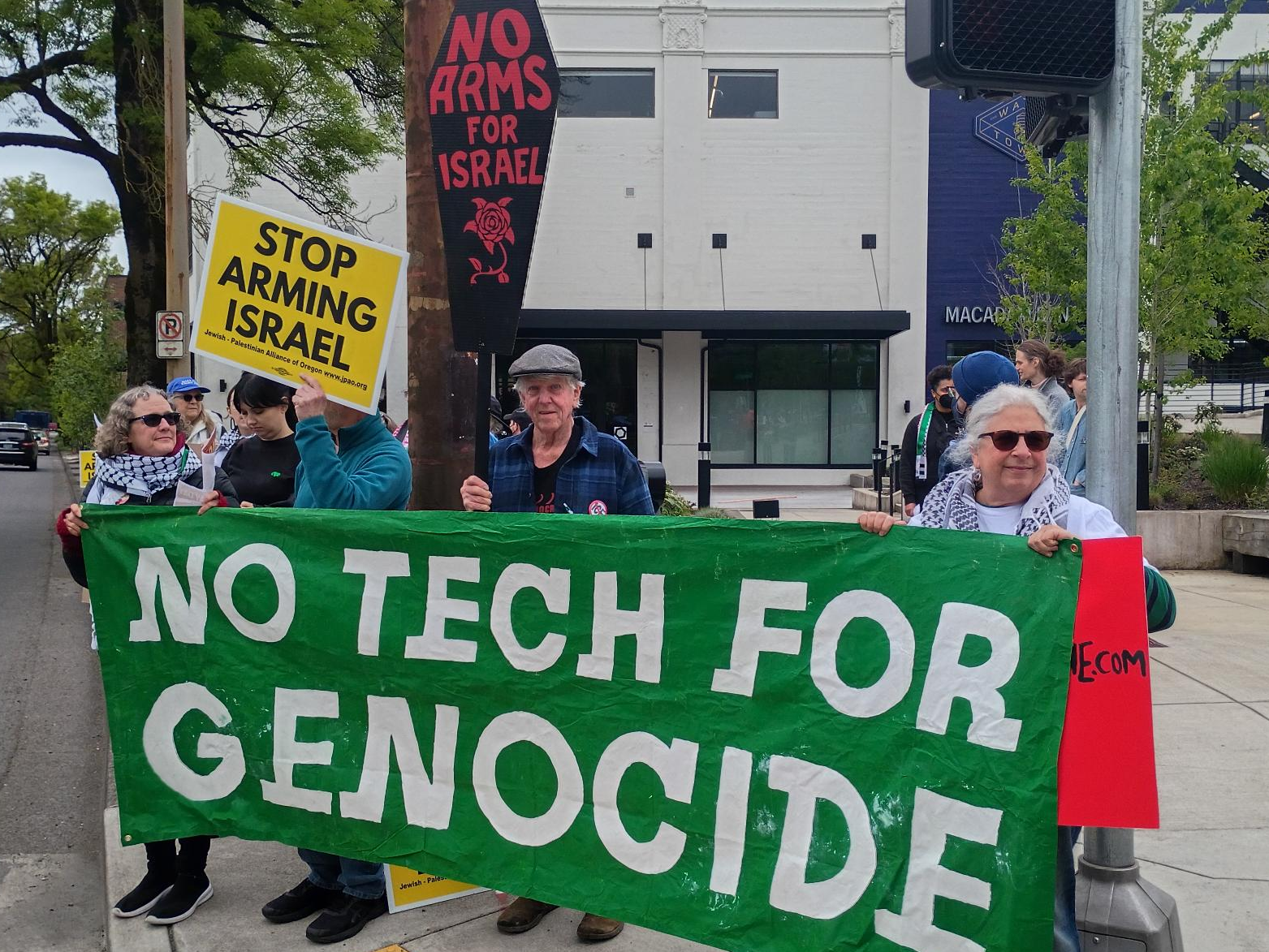 Photo of Portland DSA and allies picketing Sightline Intelligence in SW Portland. Sightline is a Portland-based company that provides AI targeting hardware and software for Elbit Systems, Israel's largest weapons manufacturer.